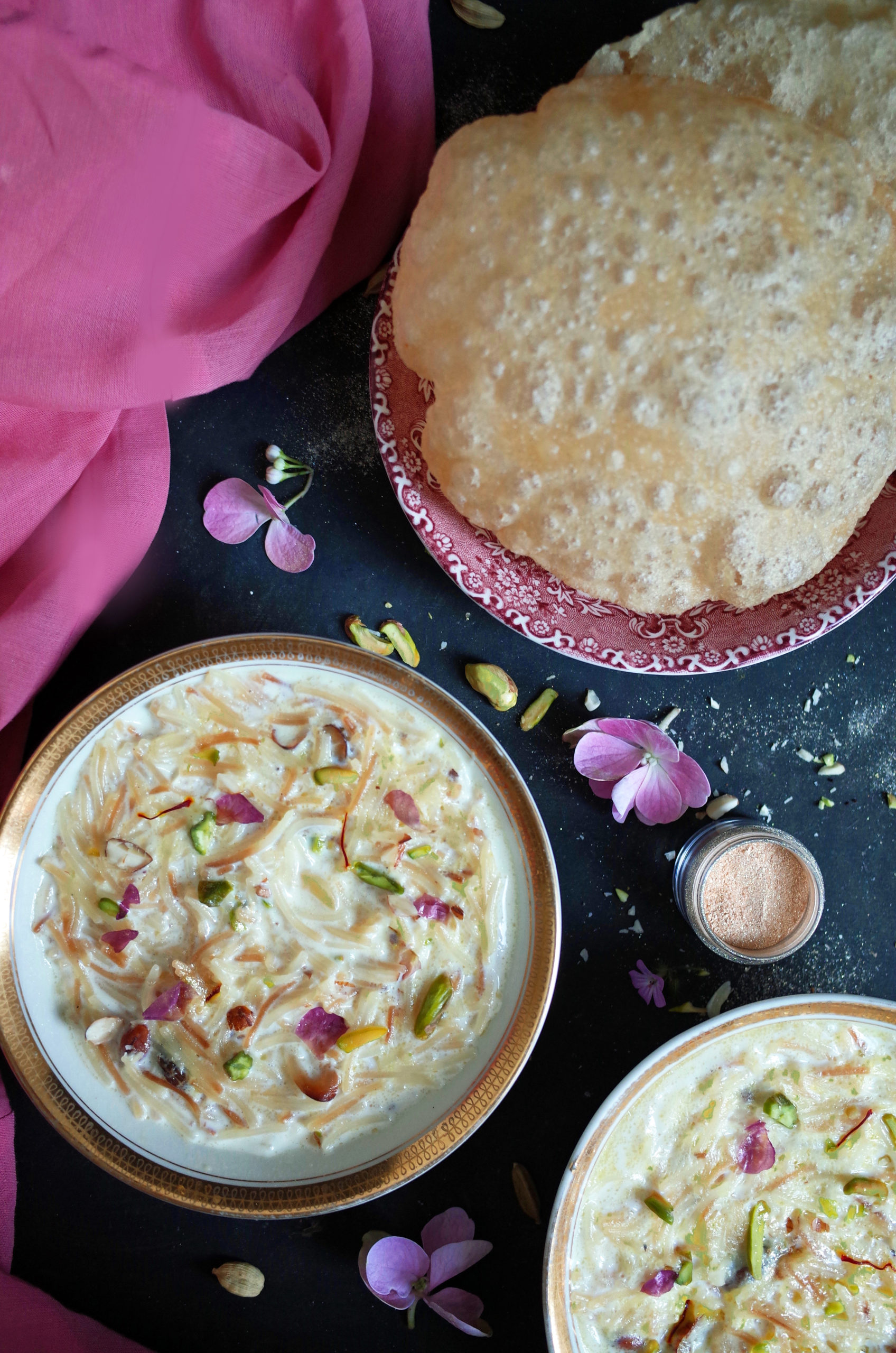 Seviyan Kheer topped with pistachios and rose petals with puri on the side