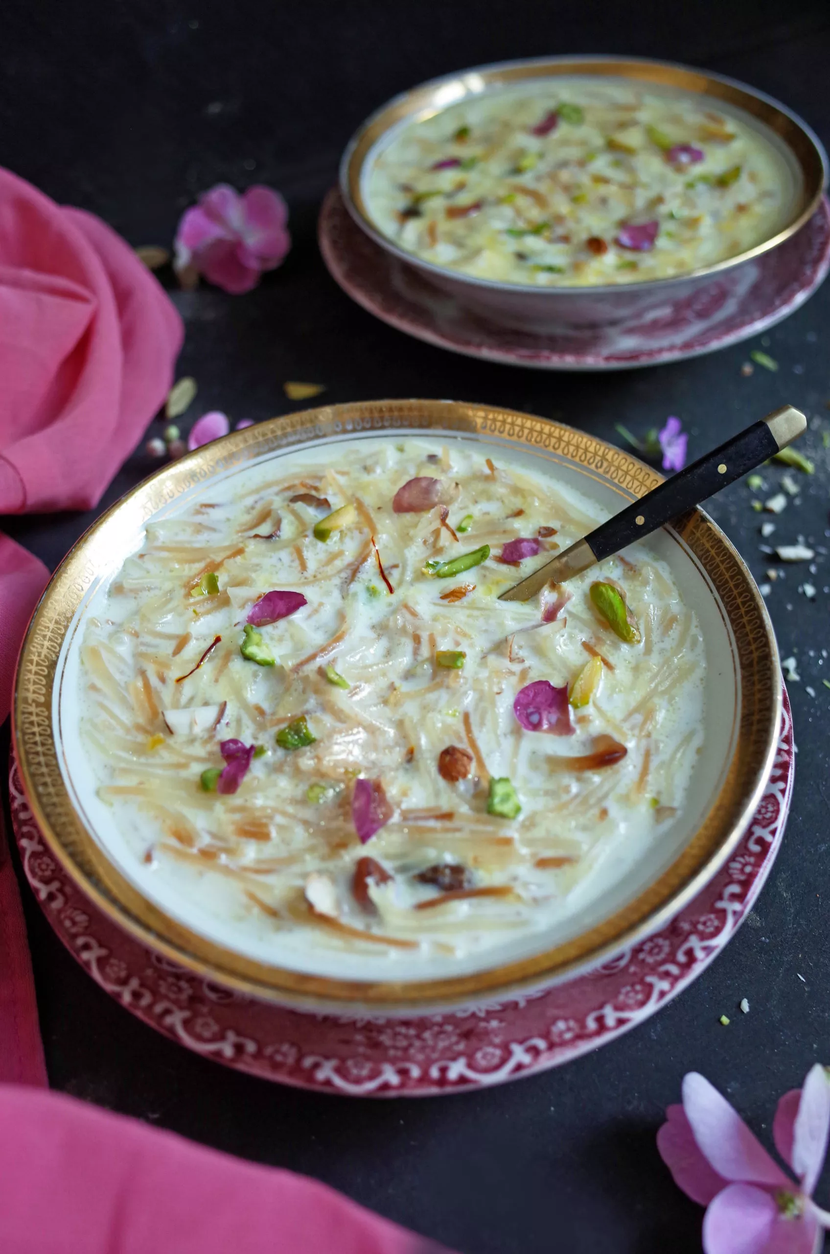 Seviyan Kheer topped with rose and pistachio in a white and gold bowl