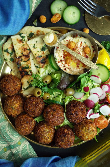 A Middle Eastern platter with Falafels, Hummus, Naan Bread and Salad