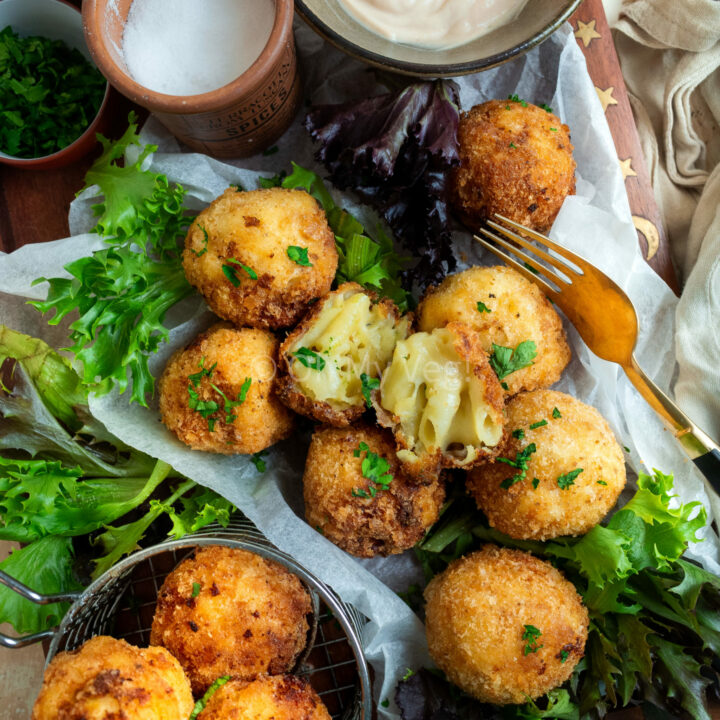 Mac and cheese bites on a plate with mayonnaise and salad