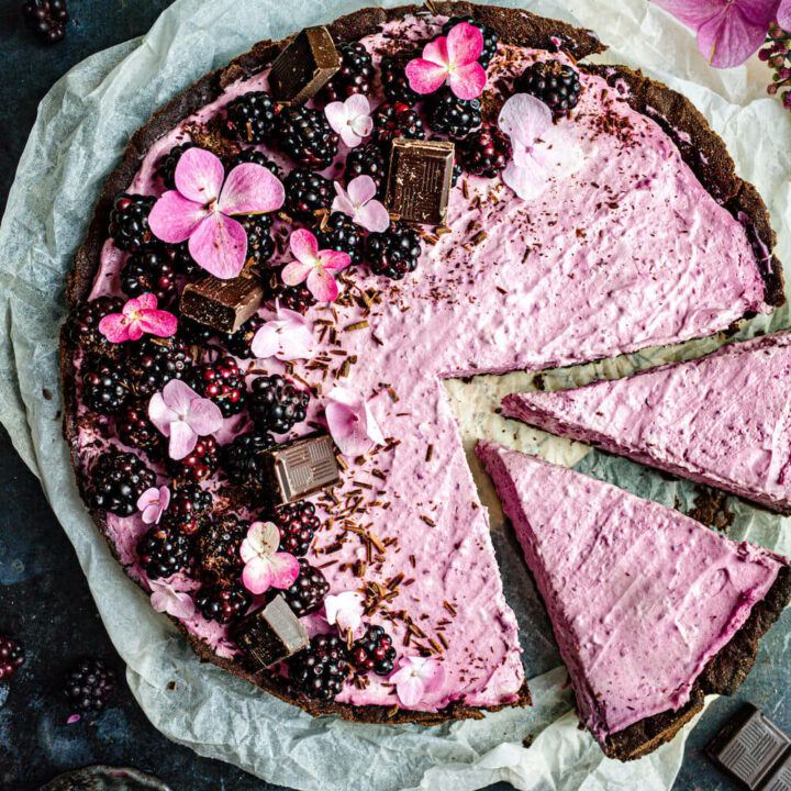 Blackberry and chocolate mascarpone tart with two slices cut out.