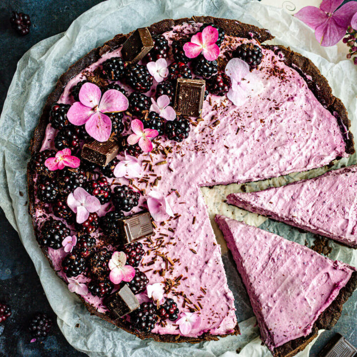 Blackberry and chocolate mascarpone tart with two slices cut out.