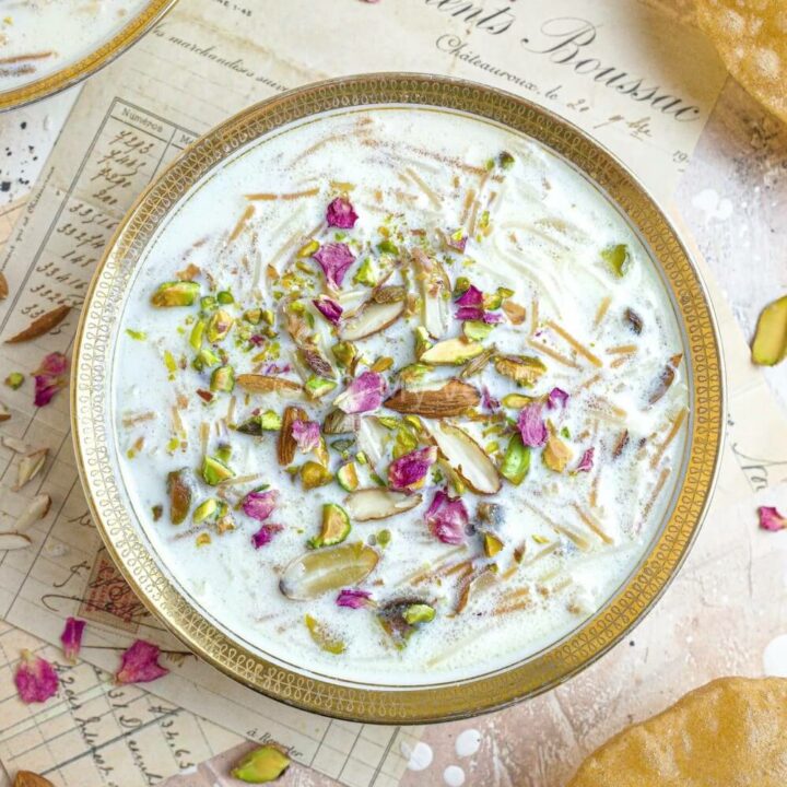 Seviyan kheer in a white bowl with puris.