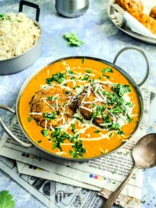 Malai kofta curry in a kadai.