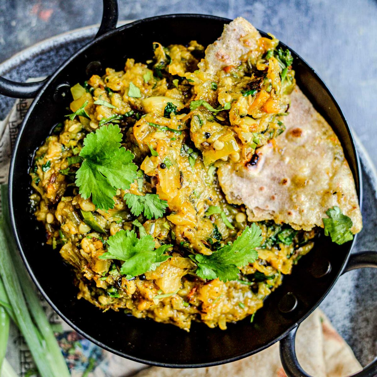 Maharashtrian vangyache bharit garnished with coriander, and served with chapati.