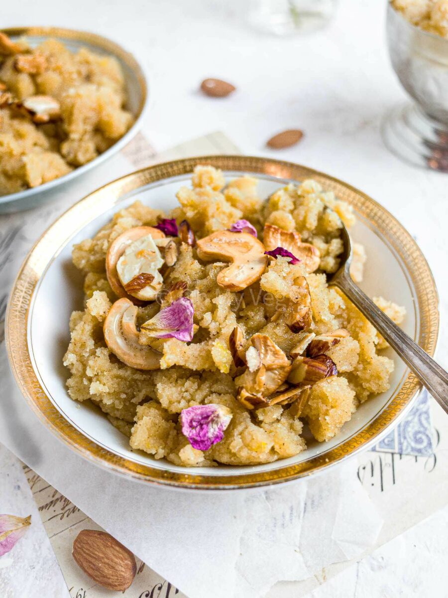 Sheera topped with nuts, in a white gold-rimmed bowl. 