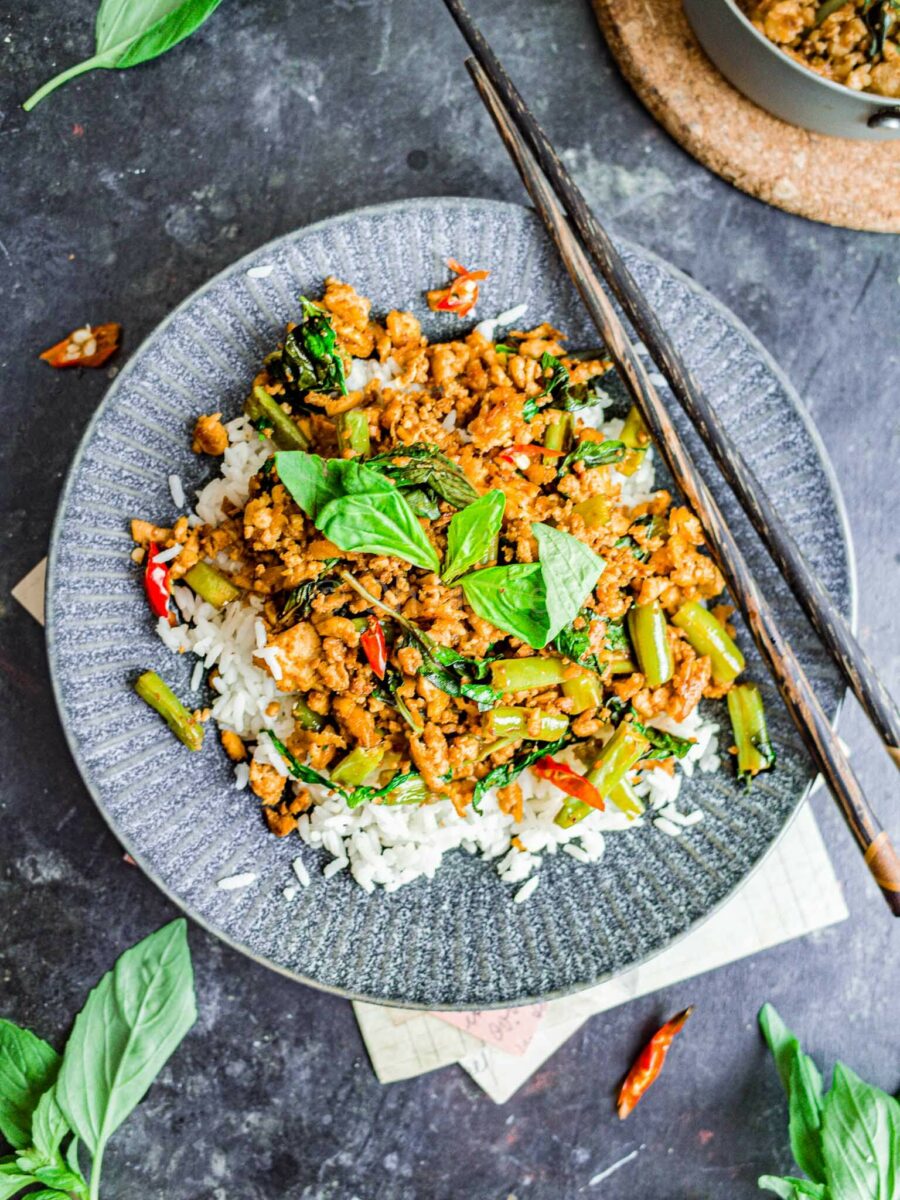 Vegan thai basil tofu stir fry with rice on a plate. 