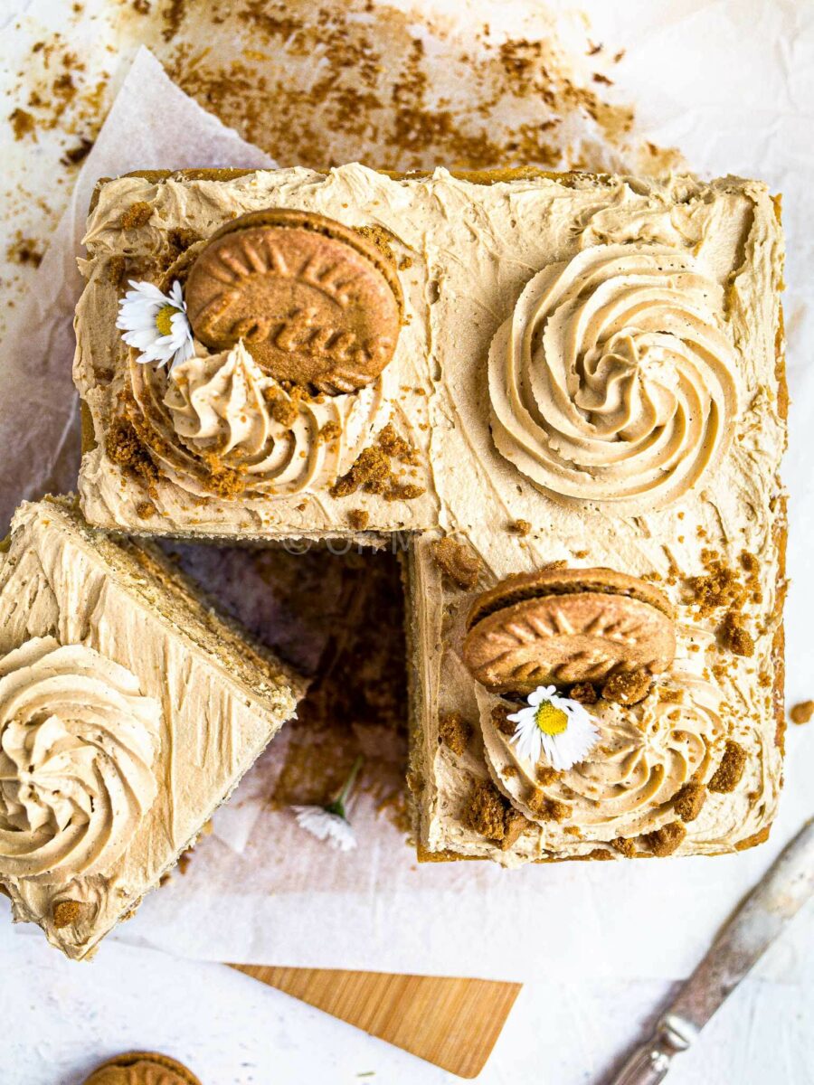 Banana and Biscoff cake from above, with a square slice cut out. 