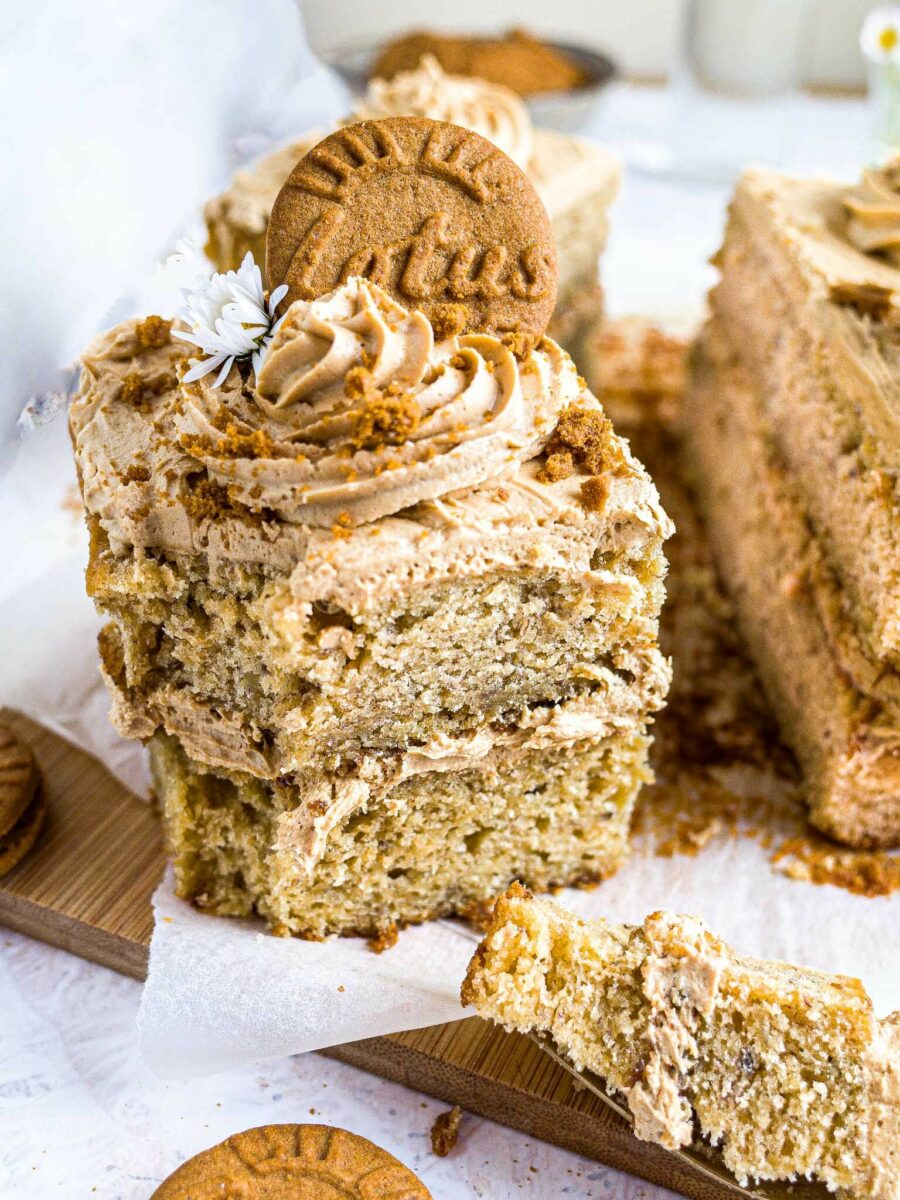 A slice of banana and Biscoff cake with a piece cut out. 