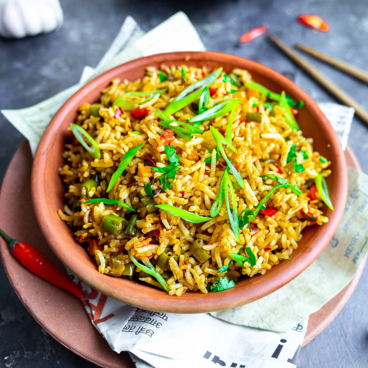 Indo-Chinese chilli garlic fried rice in a clay bowl.