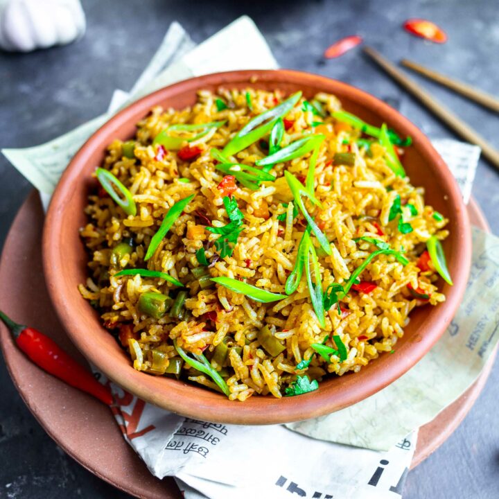 Indo-Chinese chilli garlic fried rice in a clay bowl.