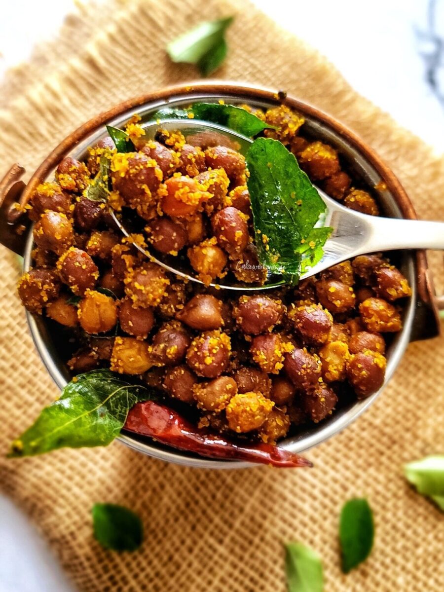 Kala chana sundal on a metal spoon.