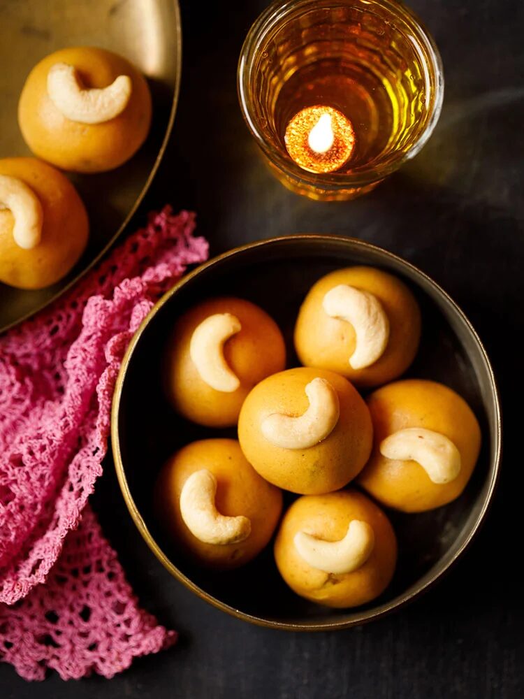 Besan ladoo in a gold bowl.