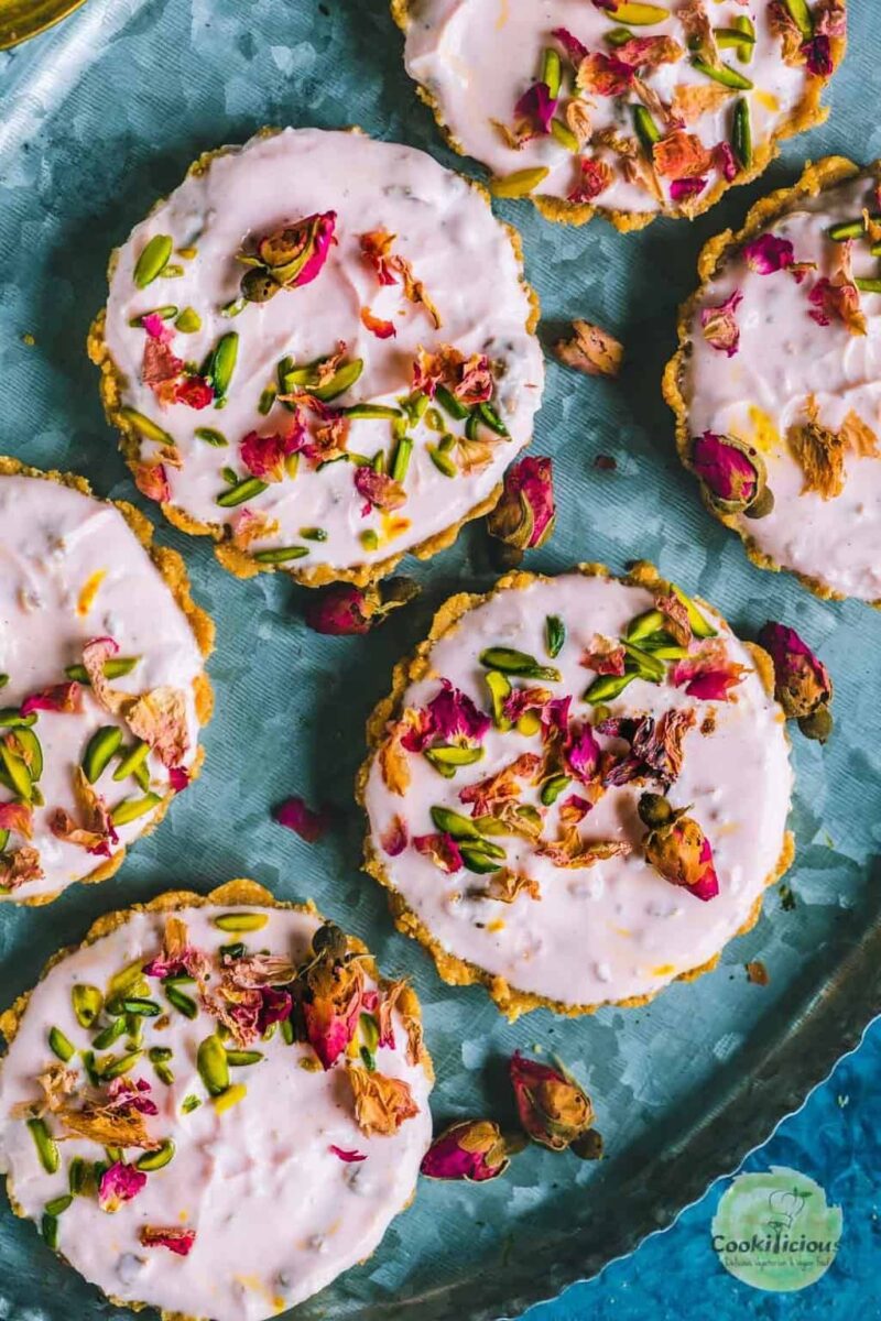 Fusion gulkand shrikhand tarts garnished with rose petals.