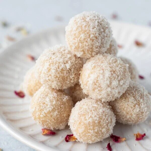 Coconut almond ladoo on a white plate.