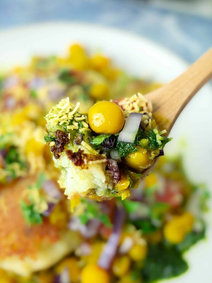 Wooden spoon holding ragda pattice.