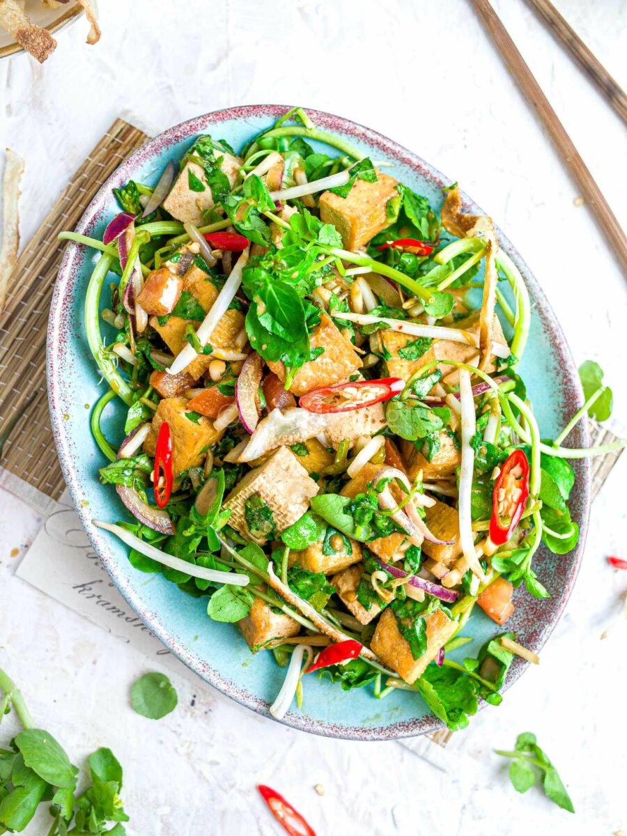 Hawaiian tofu watercress salad on a blue plate.