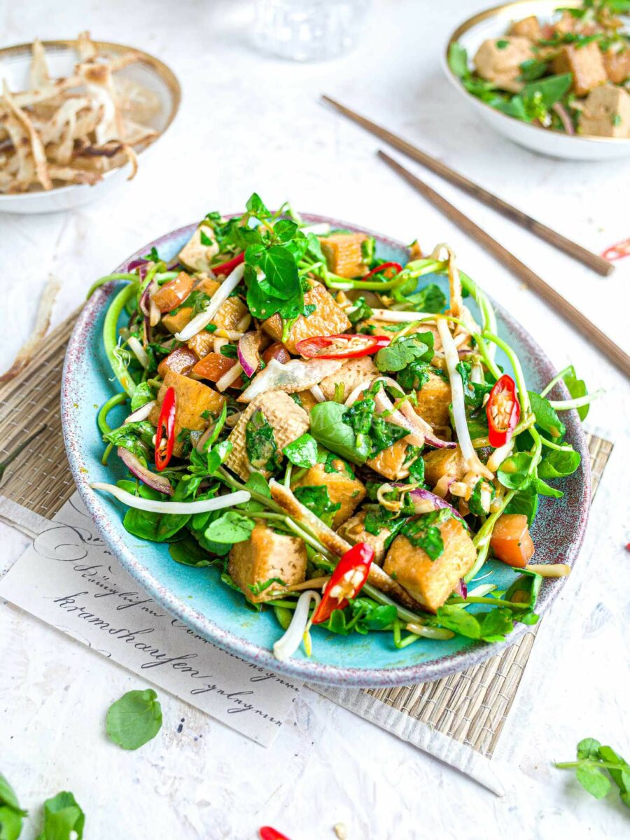 Vegan tofu watercress salad on a white background. 