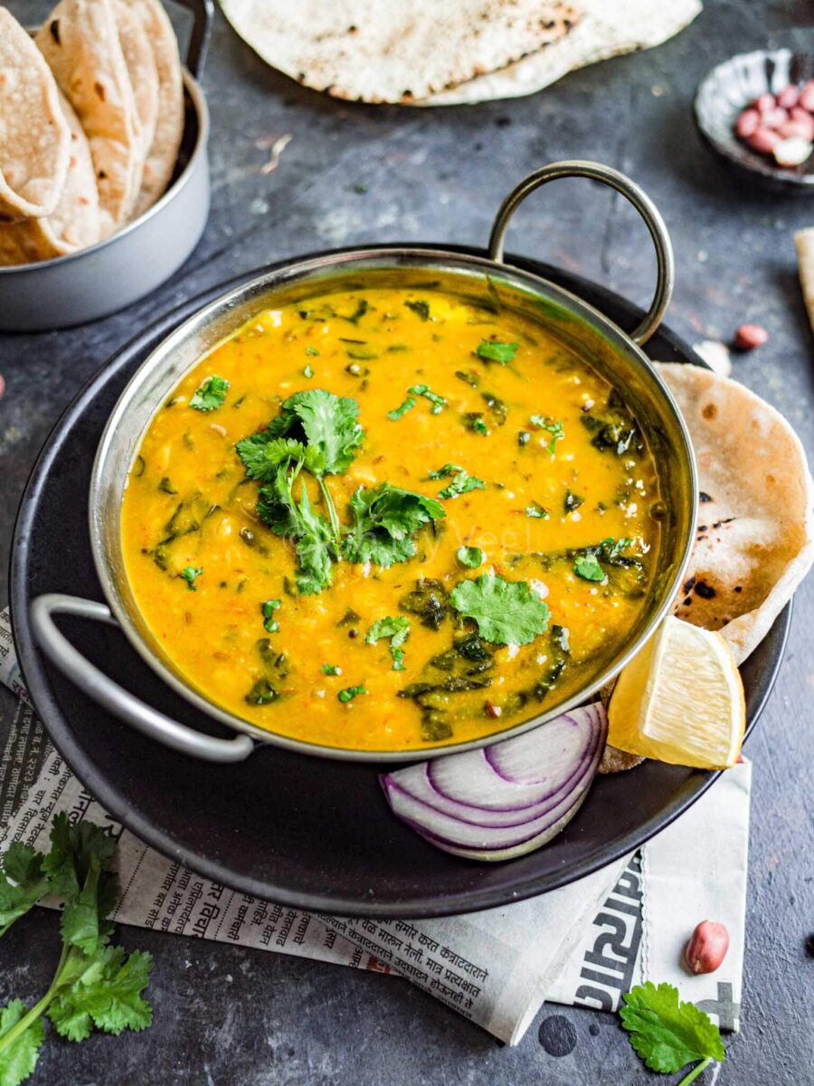 Dal bhaji in a metal kadai, seen from the side.