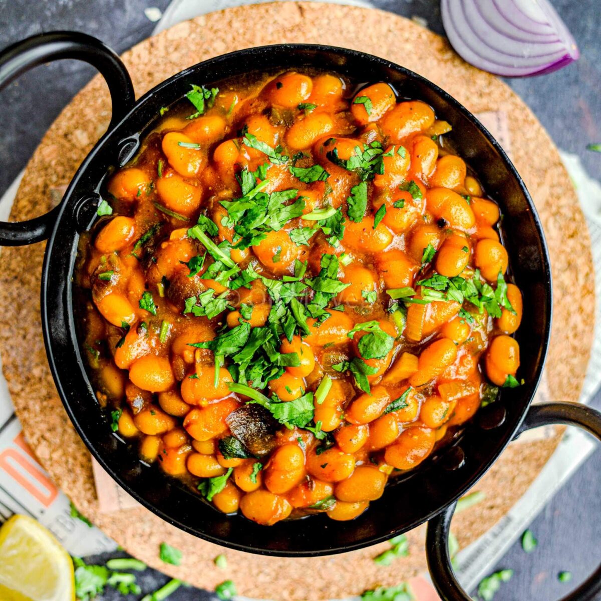 Masala beans in a black kadai.