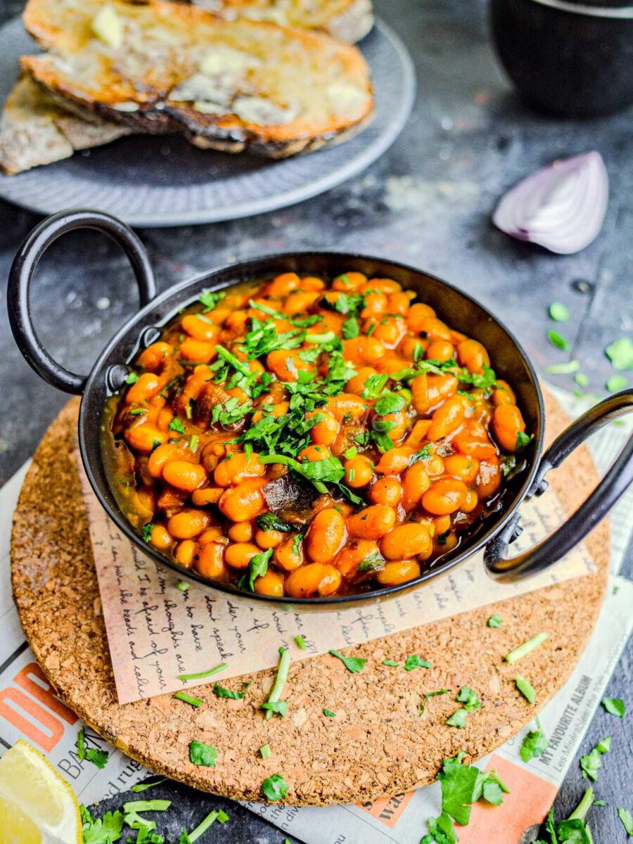 Masala beans in a small black bowl.