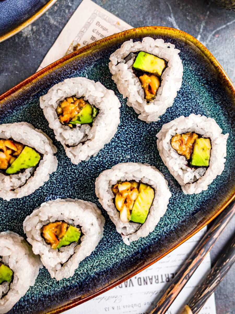 Peanut avocado rolls on a blue plate.