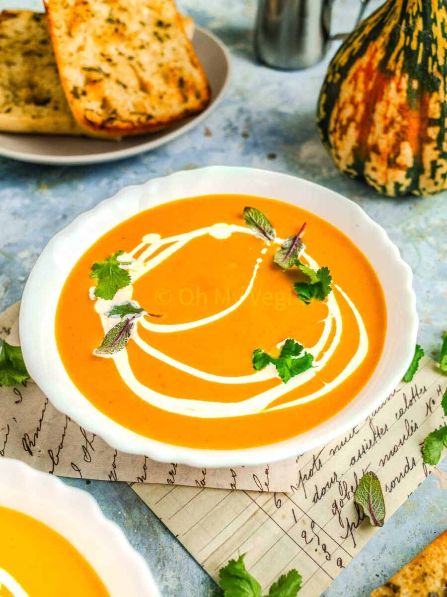 Pumpkin and sweet potato soup in a white bowl.