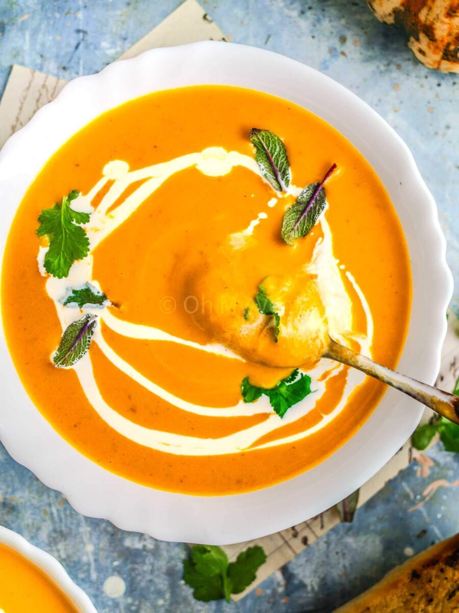 Pumpkin and sweet potato soup with a spoon.