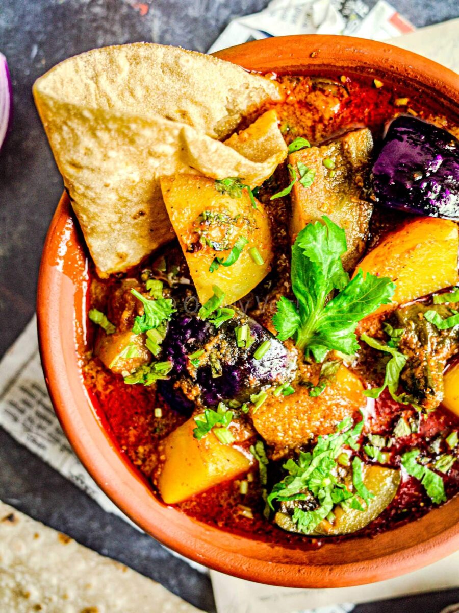 Vangi batata rassa in a clay bowl with chapati.