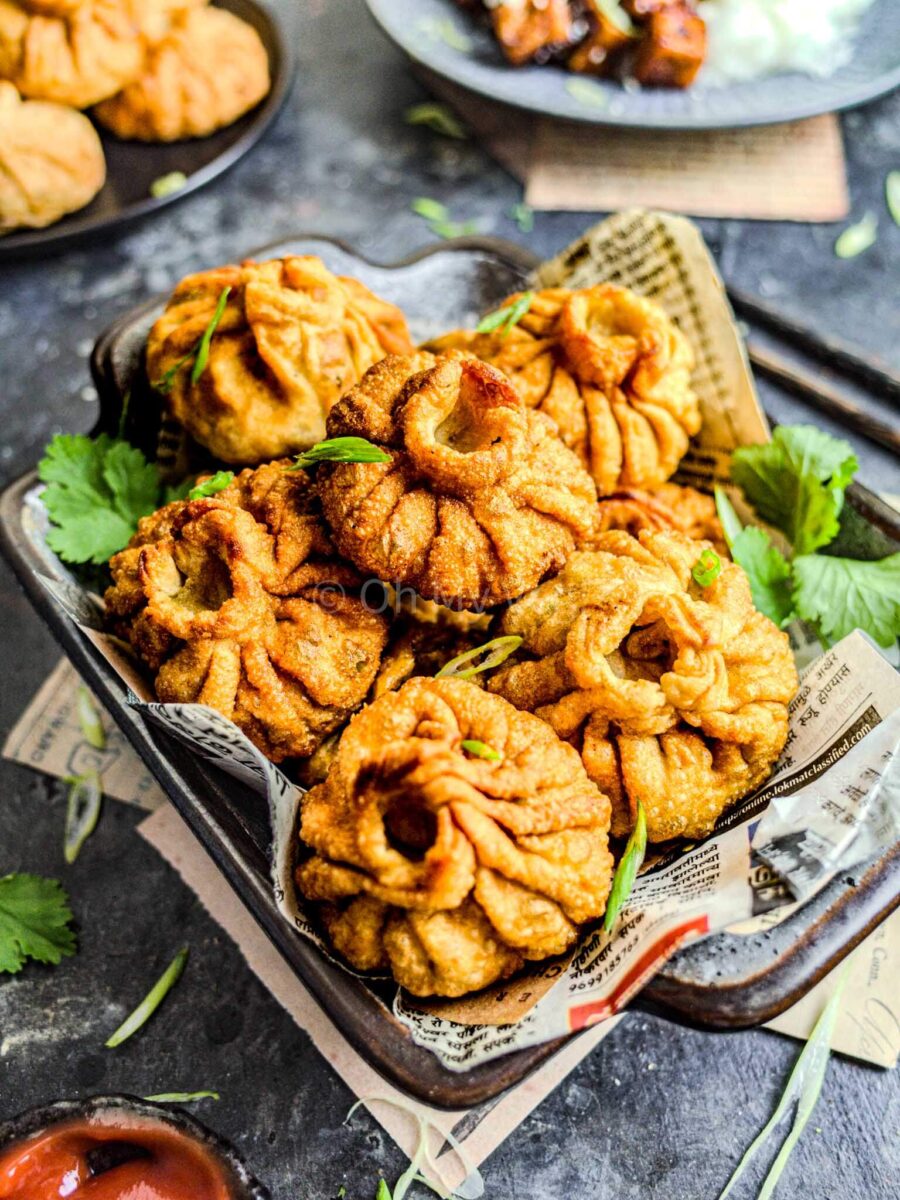 Fried momos on a small tray.