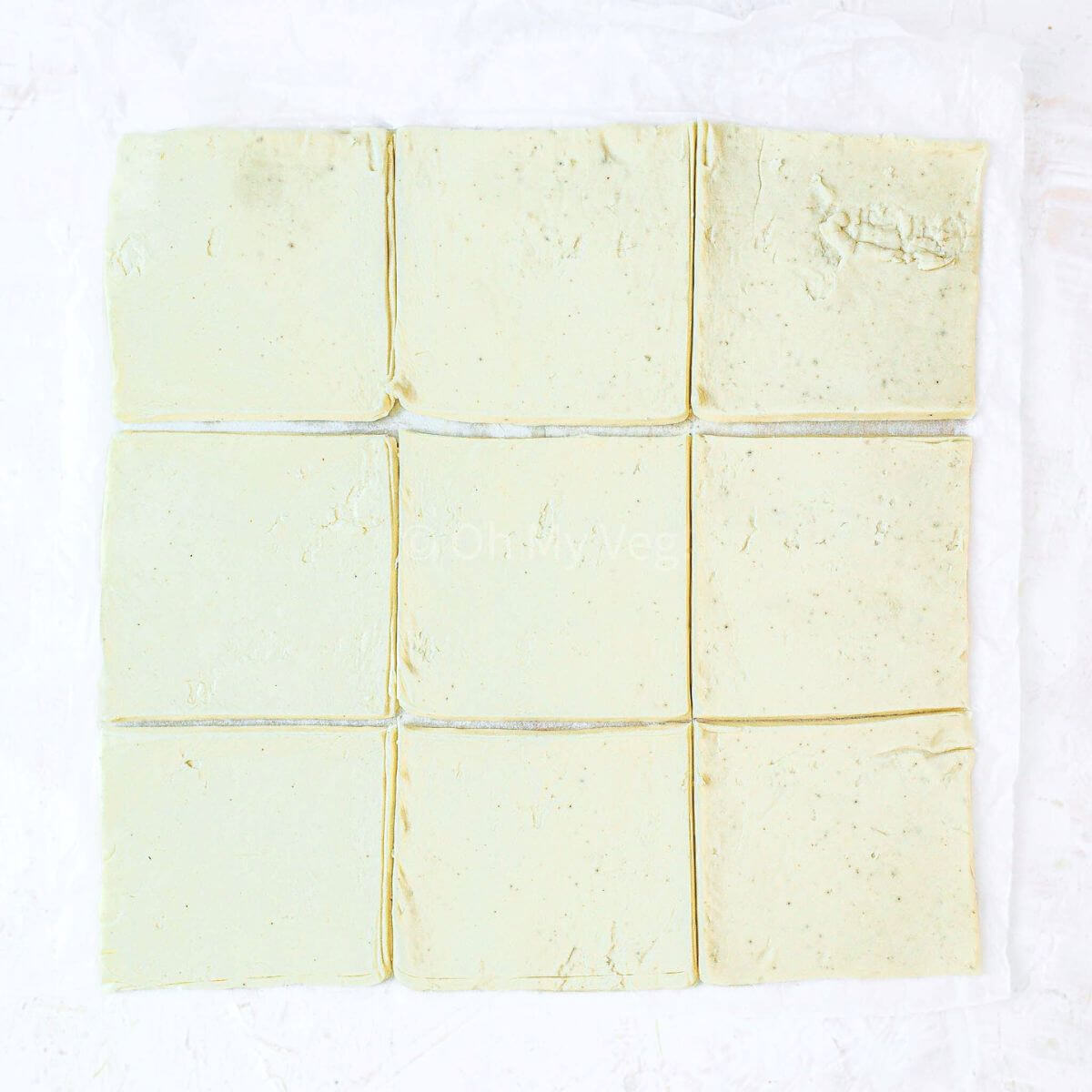 Sheet of puff pastry cut into 9 squares.