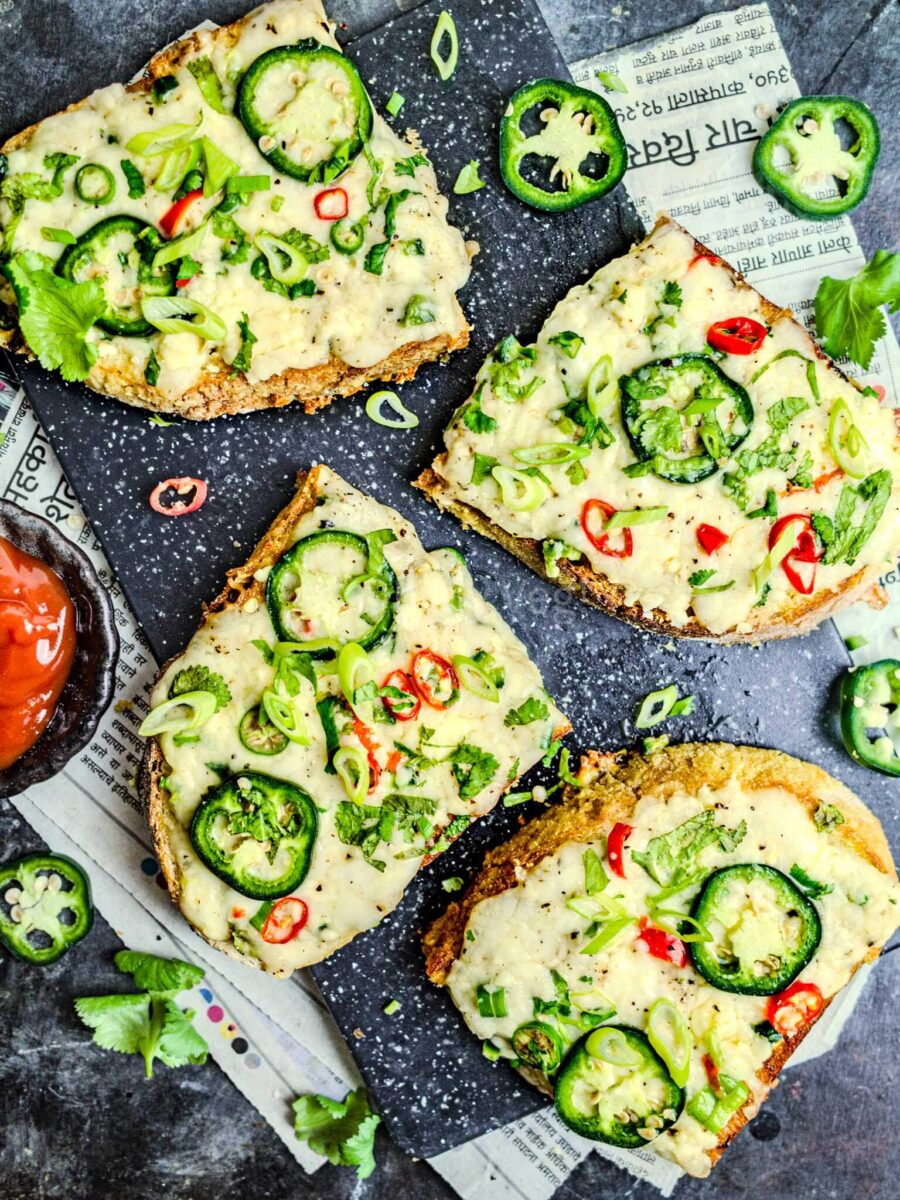 Chilli cheese toast on a black board.