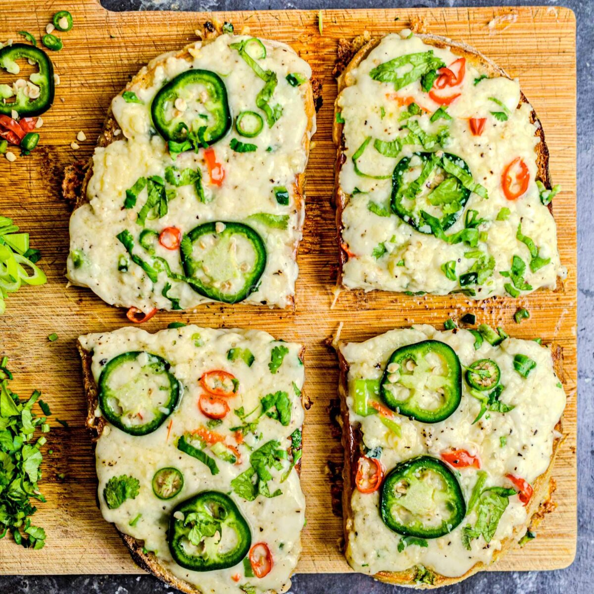 Chilli cheese toast cut on a chopping board.