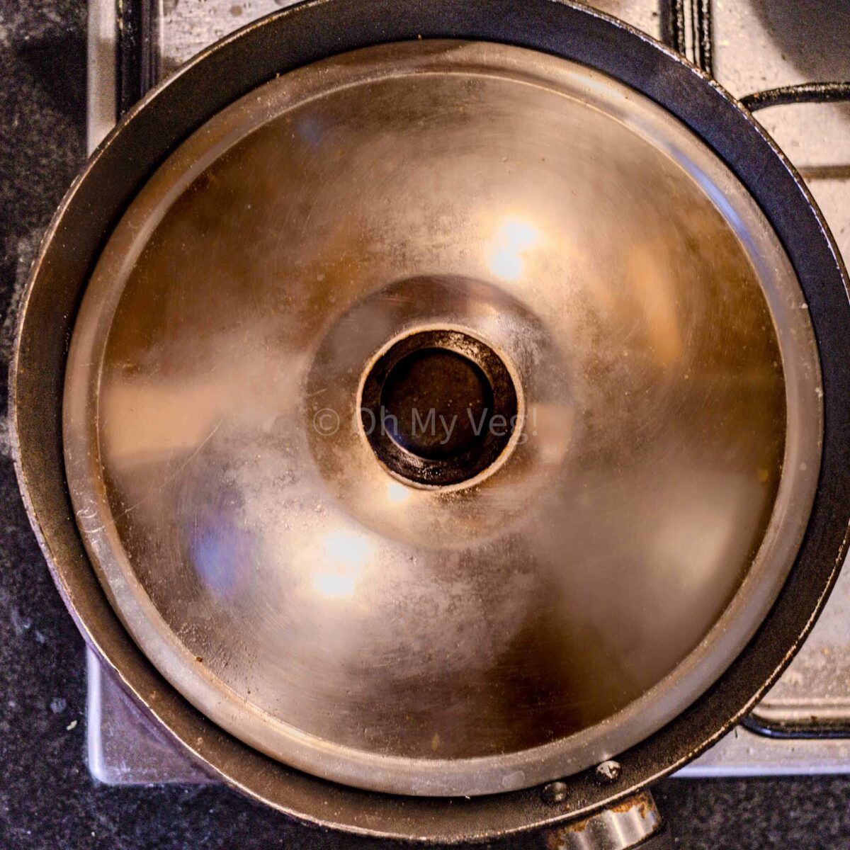 A frying pan covered with a lid. 