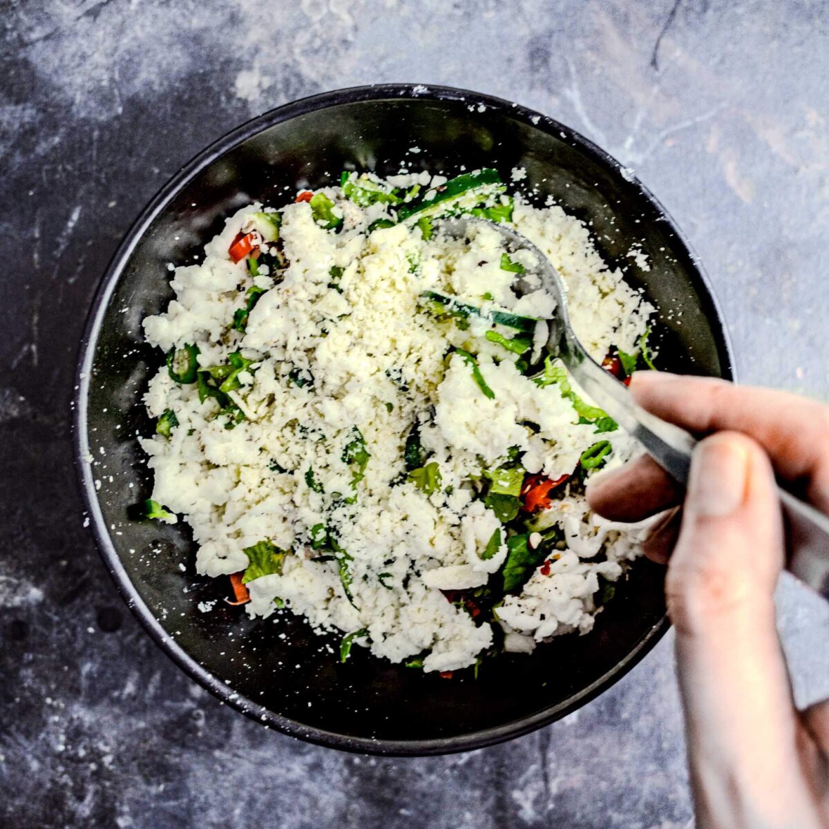 Mixing seasonings into cheese.