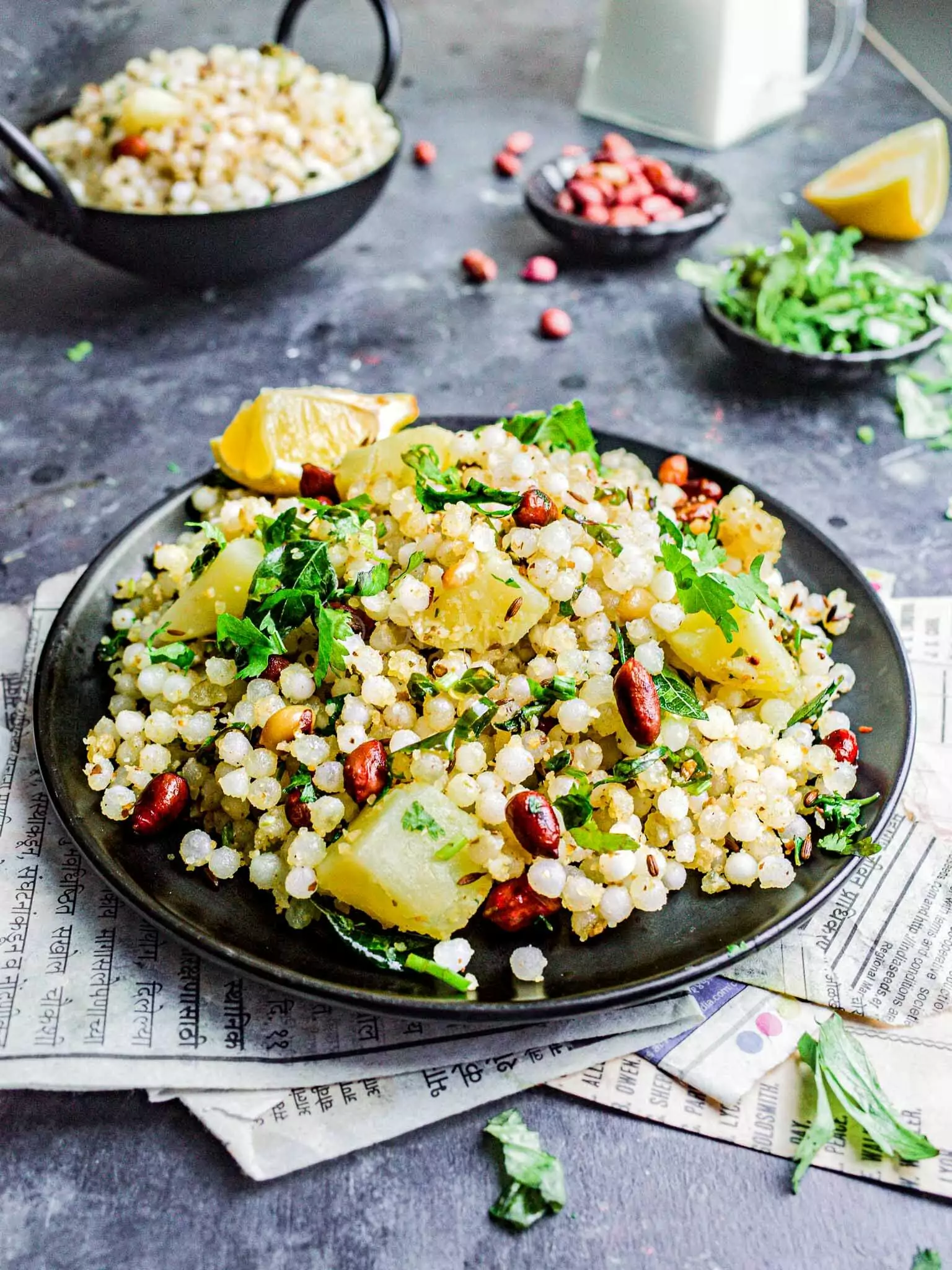 Sabudana khichdi on a black plate. 