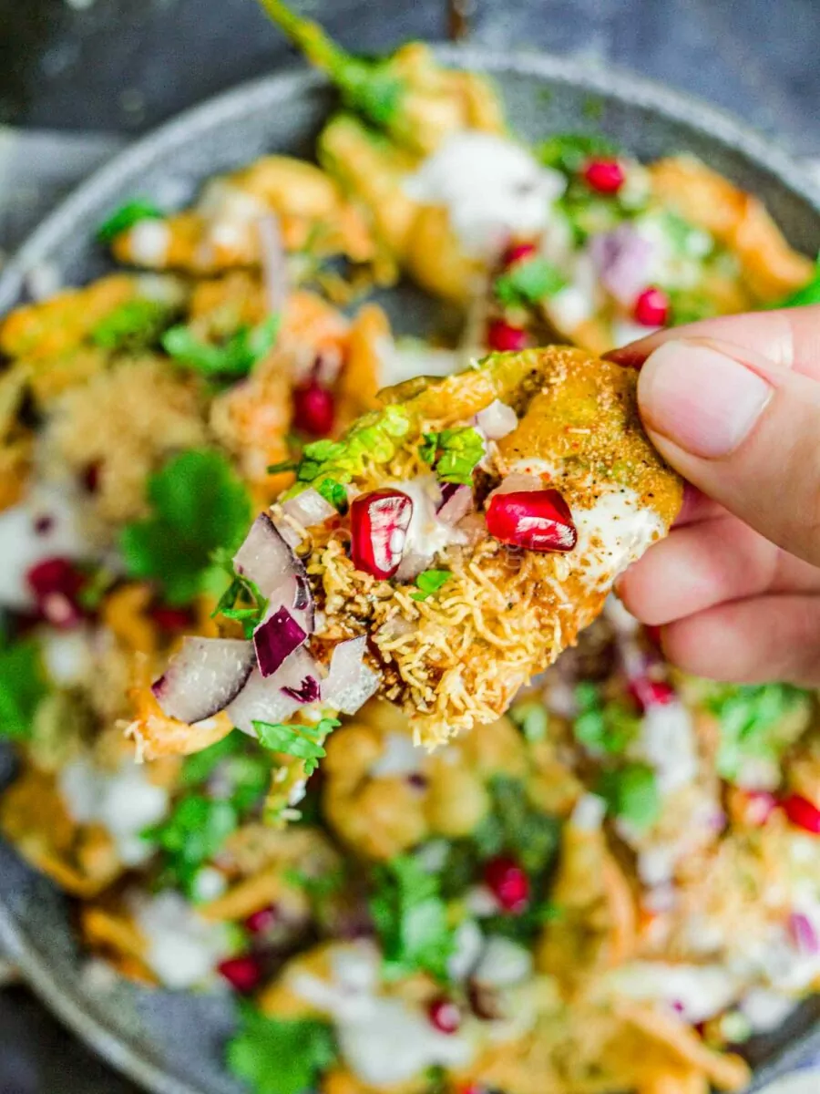 Hand holding Indian crispy leaves.