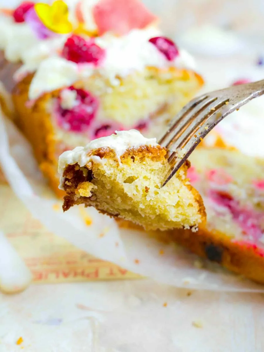 Fork with a piece of peach melba loaf cake. 